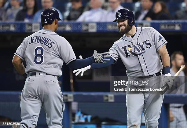 Desmond Jennings of the Tampa Bay Rays is congratulated by Curt Casali after hitting a solo home run in the ninth inning during MLB game action...