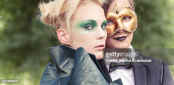 young couple on carnival - masquerade mask stock pictures, royalty-free photos & images