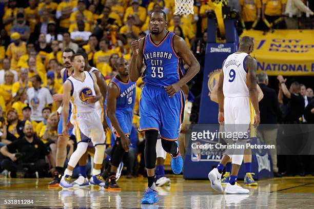 Kevin Durant of the Oklahoma City Thunder reacts after a basket in the fourth quarter against the Golden State Warriors during game one of the NBA...