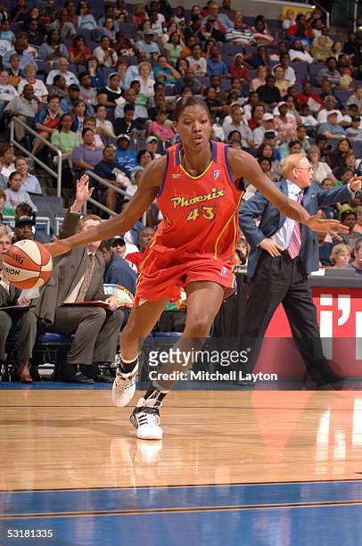 Angelina Williams of the Phoenix Mercury moves the ball against the Washington Mystics during a WNBA game June 21, 2005 at the MCI Center in...
