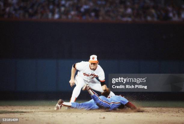 Cal Ripken, Jr. #8 of the Baltimore Orioles attempts to tag out a runner at second base during a 1983 World Series game against the Philadelphia...