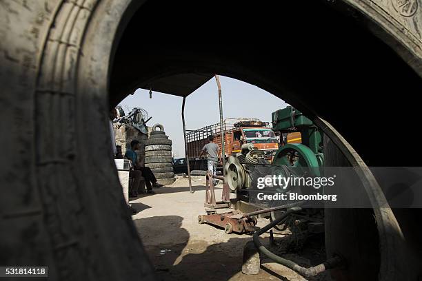 Workers and truckers make repairs at a tyre repair workshop on National Highway 8 in Haryana, India, on Saturday, May 14, 2016. Rivigo Services Pvt....