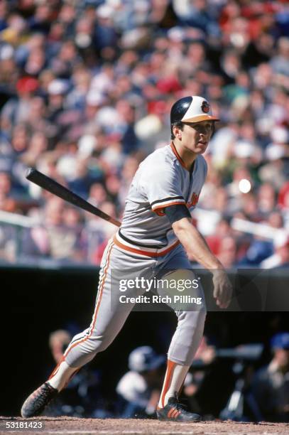 Cal Ripken, Jr. #8 of the Baltimore Orioles watches the flight of the ball as he follows through on his swing during a 1983 World Series game against...