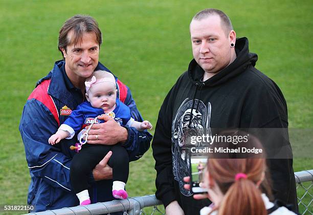 Bulldogs head coach Luke Beveridge poses with a baby for fans during a Western Bulldogs AFL training session at Whitten Oval on May 17, 2016 in...