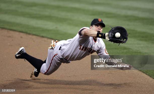 First baseman J.T. Snow of the San Francisco Giants tries to catch a line drive hit by Xavier Nady of the San Diego Padres in the first inning on...