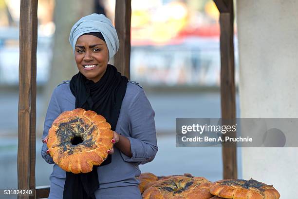 Nadiya Hussain poses with a Great Fire of London inspired bake during a photocall opening a new experience at The London Dungeon, which marks the...
