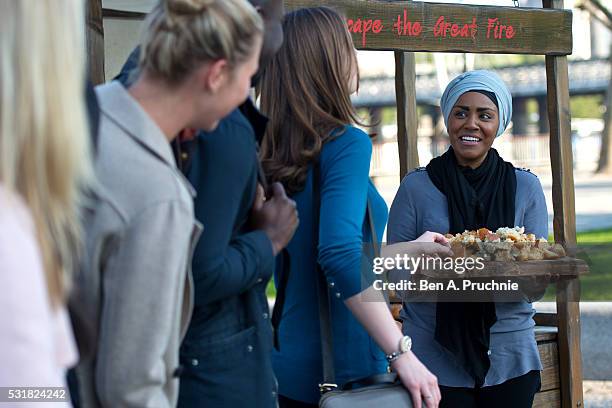 Nadiya Hussain poses with a Great Fire of London inspired bake during a photocall opening a new experience at The London Dungeon, which marks the...