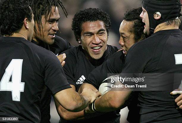 All Blacks Rico Gear, Rodney So'oialo, Mils Muliaina, Tana Umaga and Richie McCaw celebrate Umaga's try during the second test between the British...