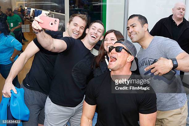 Chris Ryan, Johnny "Joey" Jones, Steve Weatherford, and J.W. Cortes pose with a fan at Boot Campaign's Pushups for Charity at the Microsoft Flagship...