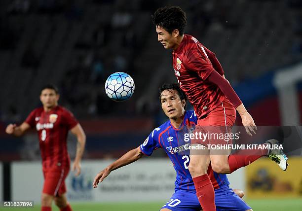 China's Shanghai SPIG forward Yu Hai traps the ball in front of Japan's FC Tokyo forward Ryoichi Maeda during the AFC champions league round of 16...