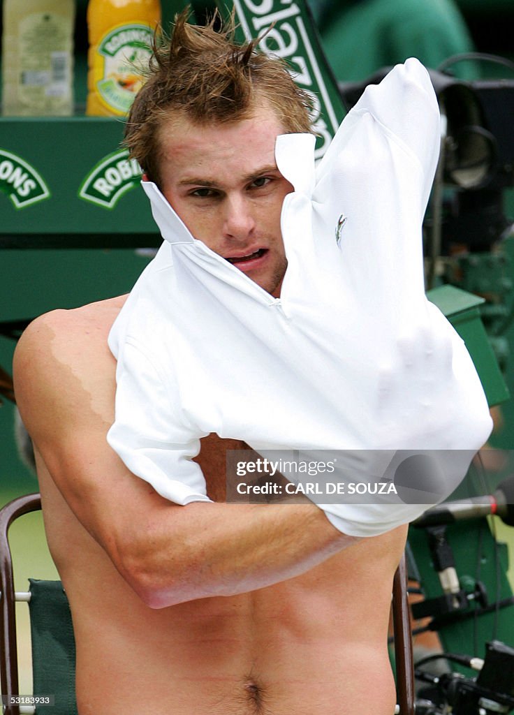 Andy Roddick Modeling Andy Roddick of US changes his shirt on a change over with Thomas ...