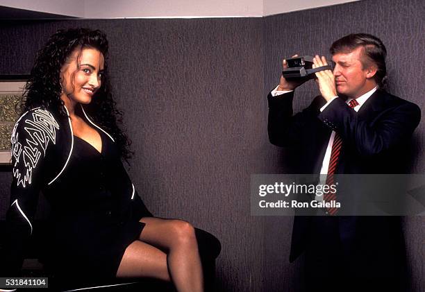 Donald Trump photographs aspiring Playboy model Lisa Madison during Playboy Magazine's 40th Anniversary Party, May 3, 1993 at the Park Hyatt Hotel in...