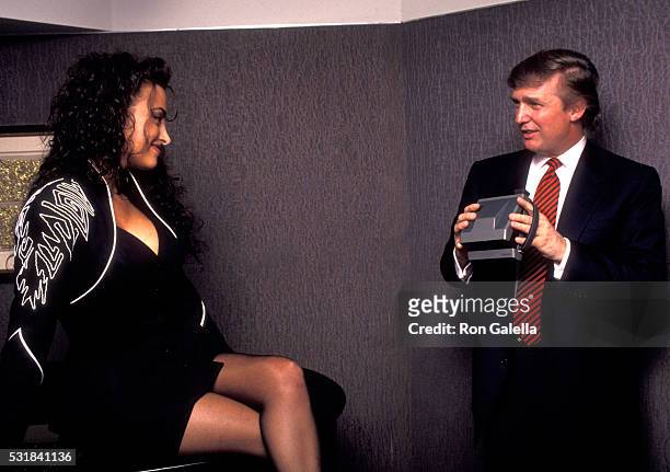 Donald Trump photographs aspiring Playboy model Lisa Madison during Playboy Magazine's 40th Anniversary Party, May 3, 1993 at the Park Hyatt Hotel in...