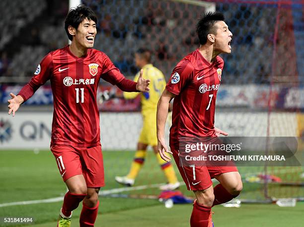 China's Shanghai SPIG forward Wu Lei shouts in jubilation after scoring a goal beside forward Lu Wenjun during the AFC champions league round of 16...