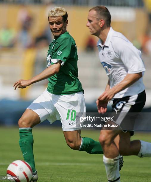 Andres DAlessandro of Wolfsburg competes with Adam Ledwon of Graz during the UI Cup match between VfL Wolfsburg and Sturm Graz on July 2, 2005 in...