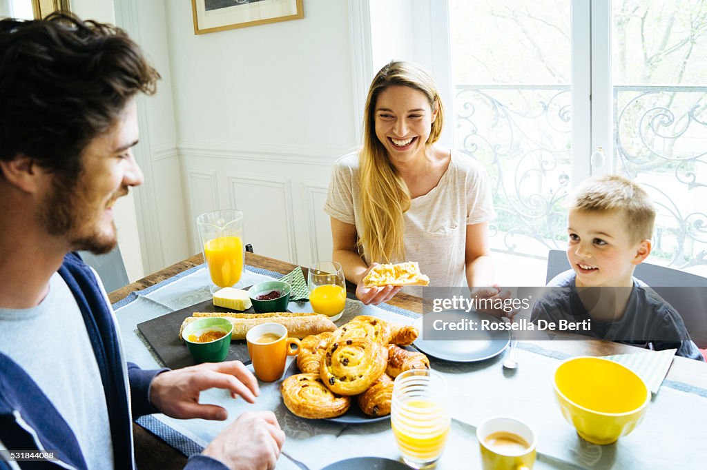 Happy Family Having Breakfast Together At Home