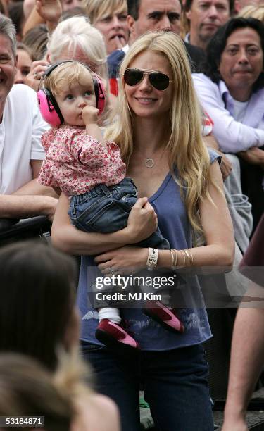 Actress Gwyneth Paltrow and daughter Apple watch Coldplay singer Chris Martin perform on stage at "Live 8 London" in Hyde Park on July 2, 2005 in...