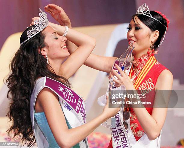 1st runner-up Sun Jia from China helps the champion, Nikoletta Ralli from Greece fix her crown after the Miss Tourism Queen International 2005 World...