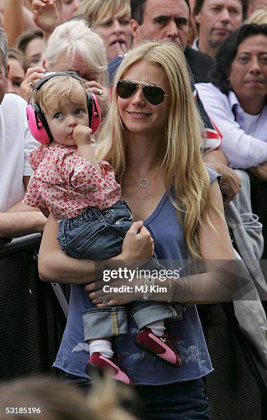 Actress Gwyneth Paltrow and daughter Apple watch Coldplay singer Chris Martin perform on stage at "Live 8 London" in Hyde Park on July 2, 2005 in...