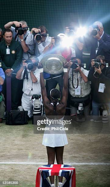 Venus Williams of USA holds the trophy as she poses for photos after Williams won in three sets against Lindsay Davenport of USA during the Ladies...