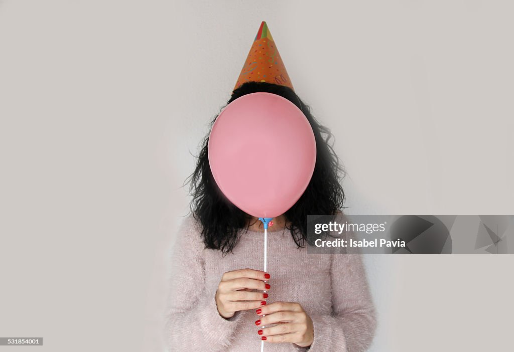 Brunette woman with balloon as face