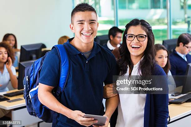 happy high school sweetheart couple in modern classroom - school uniform stock pictures, royalty-free photos & images