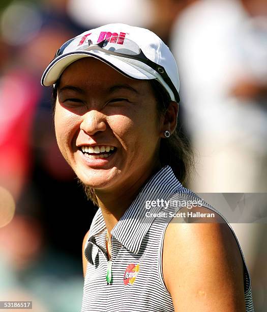 Candie Kung smiles after defeating Annika Sorenstam of Sweden 1up during the quarter-finals of the HSBC World Match Play at Hamilton Farm Golf Club...