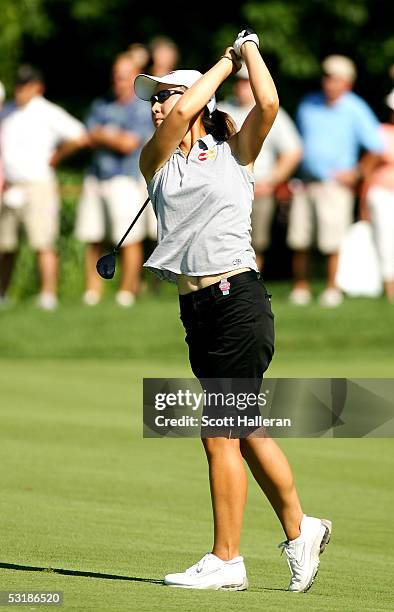 Candie Kung watches her approach shot to the 18th green during her match with Annika Sorenstam of Sweden during the quarter-finals of the HSBC World...