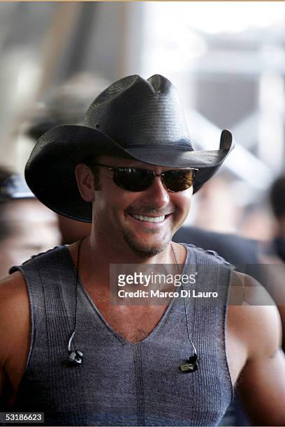 American singer Tim McGraw arrives on stage during "Live 8 Rome" at Circus Maximus on July 2, 2005 in Rome, Italy. The free concert is one of ten...