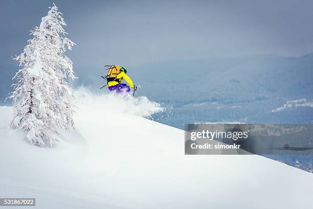 skiing in snow - snowy hill stock pictures, royalty-free photos & images