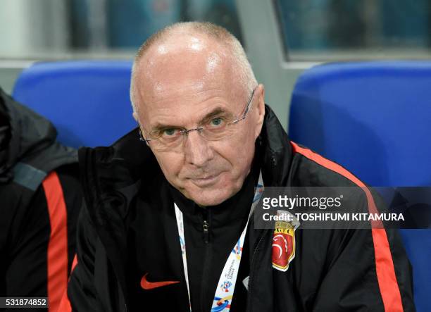 China's Shanghai SPIG head coach Eriksson Sven Goeran looks at his players prior to their AFC champions league round of 16 first match against...