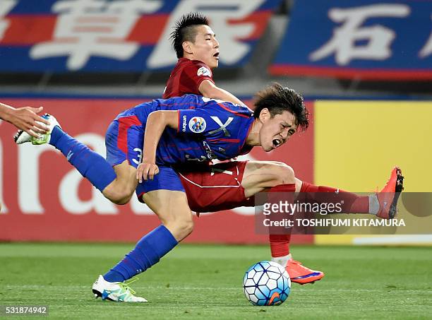 Japan's FC Tokyo defender Kento Hashimoto fights for the ball with China's Shanghai SPIG forward Wu Lei during the AFC champions league round of 16...