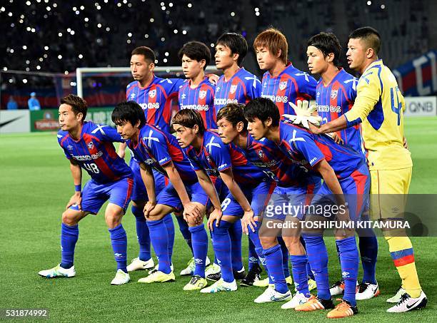 Japan's FC Tokyo starting players pose in a photo session prior to their AFC champions league round of 16 first match against China's Shanghai SPIG...