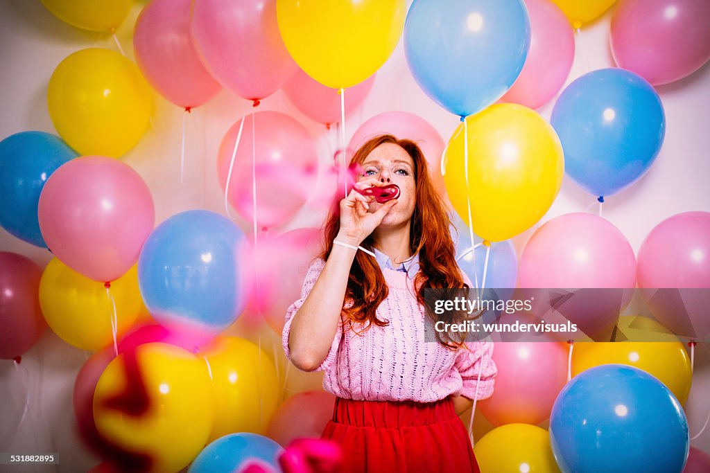 Young Woman Standing In Front Of a Balloon Wall