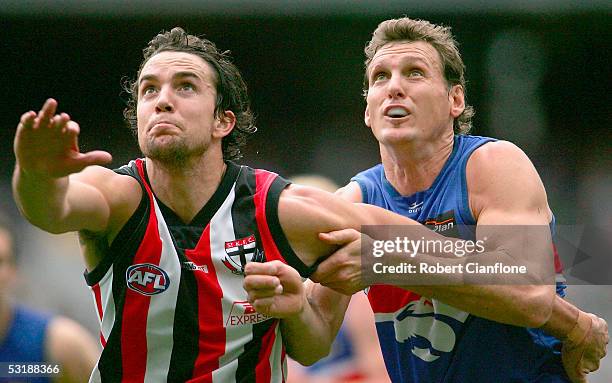 Cain Ackland of the Saints is challenged by Daniel Bandy of the Bulldogs during the round 14 AFL match between the Western Bulldogs and St Kilda...