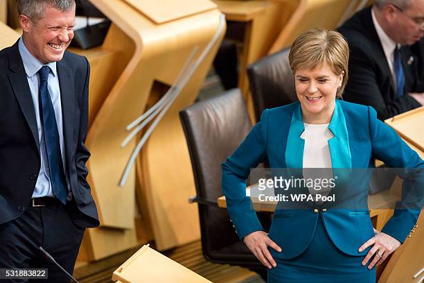 Liberal Democrat leader in Scotland Willie Rennie chats with First Minister of Scotland, Nicola Sturgeon, in the Scottish parliament before Ms...