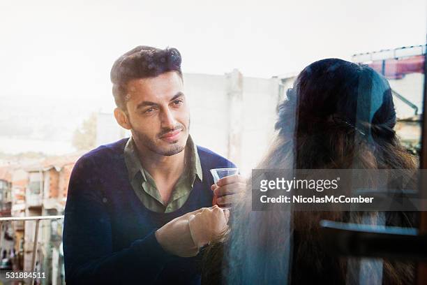 middle eastern romantic moment on balcony - istanbul tea stock pictures, royalty-free photos & images