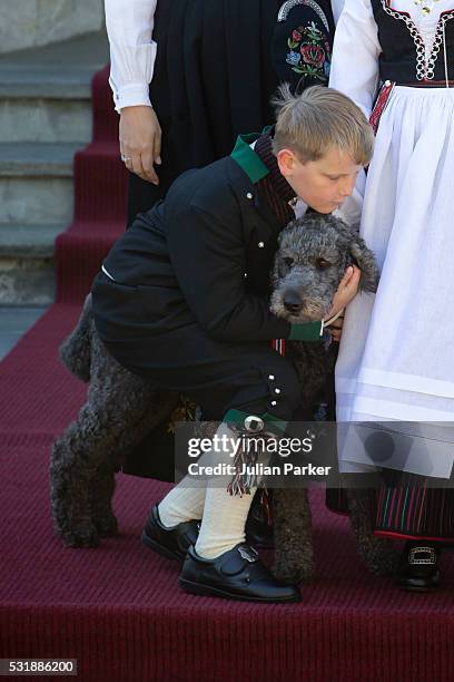 Prince Sverre Magnus of Norway, with the family pet dog Milly Kakao, attend the traditional morning children's parade, at his home, Skaugum, in...