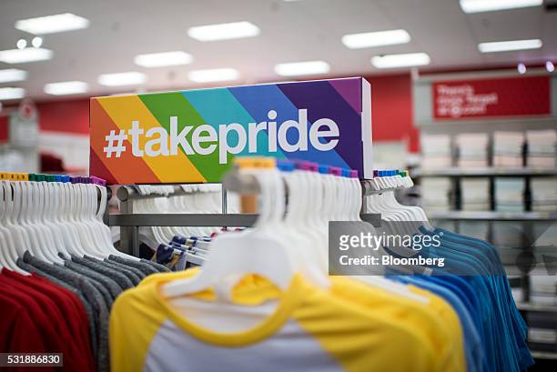 Signage for Target Corp.'s "#TakePride" initiative sits above products displayed for sale at a company store in Chicago, Illinois, U.S., on Monday,...