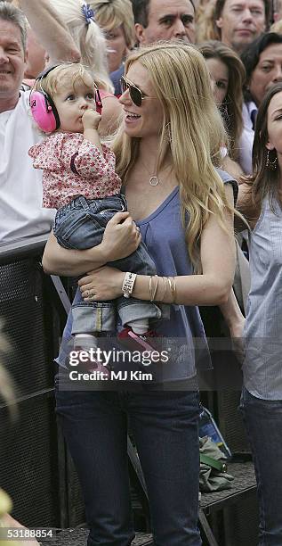 Actress Gwyneth Paltrow and daughter Apple watch Coldplay singer Chris Martin perform on stage at "Live 8 London" in Hyde Park on July 2, 2005 in...