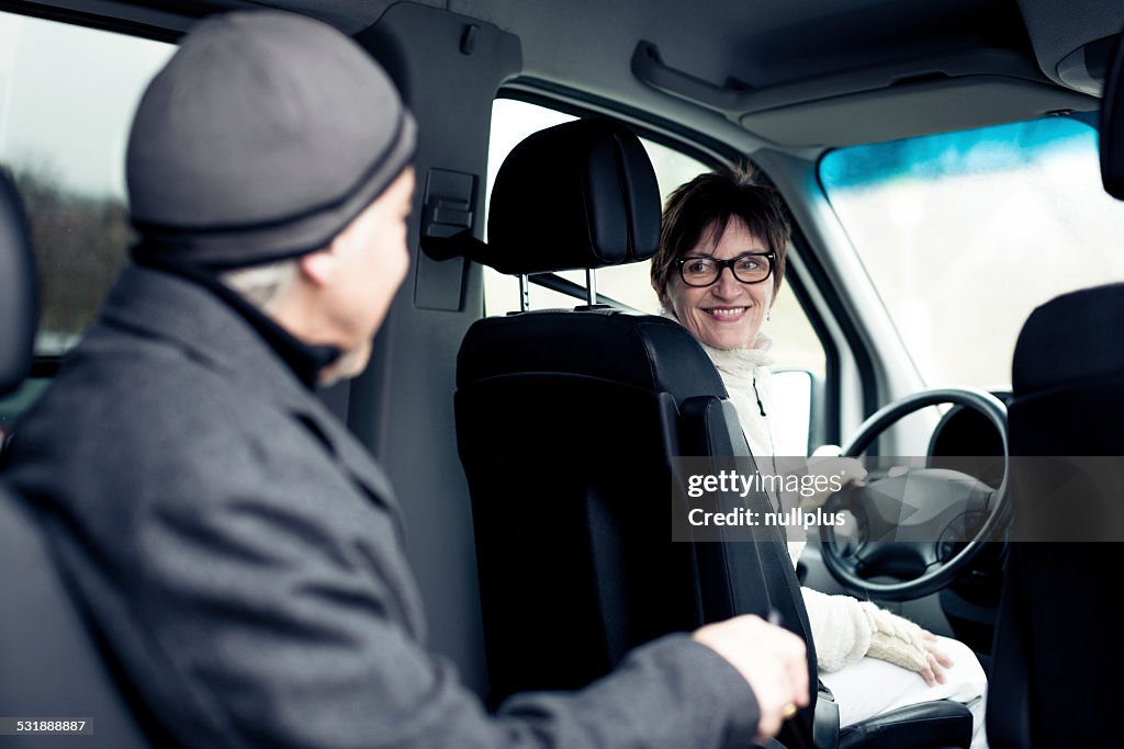 Senior man sitting in paratransit van