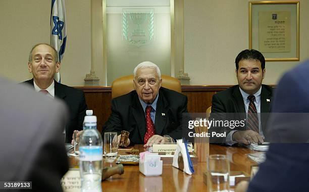 Israeli Prime Minister Ariel Sharon , Vice Prime Minister Ehud Olmert and Cabinet Secretary Israel Maimon attend the weekly cabinet meeting in his...