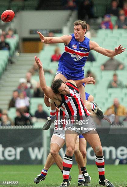 Daniel Bandy for the Western Bulldogs climbs over Cain Ackland for St Kilda during the Round 14 AFL match between the Western Bulldogs and St Kilda...