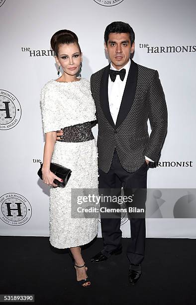 Timur Tillyaev and Lola Karimova-Tillyaeva attend The Harmonist Cocktail Party during The 69th Annual Cannes Film Festival at Plage du Grand Hyatt on...