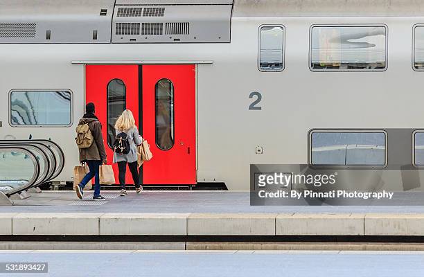 two young people catching a train - liege belgium stock pictures, royalty-free photos & images