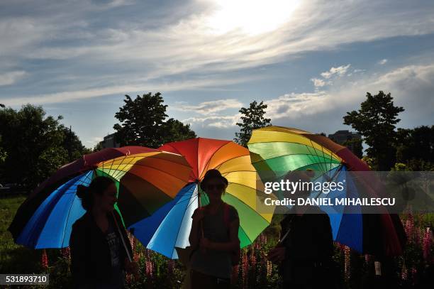 People hold raibow umbrellas to celebrate International Day Against Homophobia in front of the Romanian Parliament building in Bucharest May 17,...