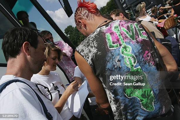 Anti-poverty activists prepare to embark on a bus to Edinburgh July 3, 2005 in central Berlin. The protesters were joining an international event...