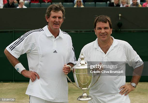 Kevin Curren of South Africa and Johan Kriek of USA celebrate with the trophy after defeating Peter McNamara of Austria and Paul McNamee of Australia...