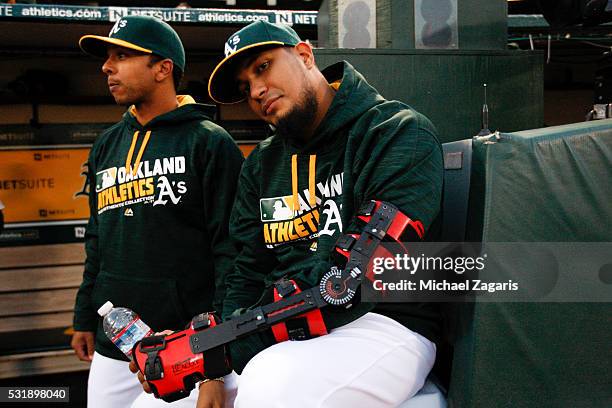 Felix Doubront of the Oakland Athletics relaxes in the dugout as he recovers from Tommy John surgery during the game against the Houston Astros at...