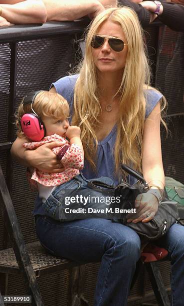 Gwyneth Paltrow holds her daughter Apple as she watches "Live 8 London" in Hyde Park on July 2, 2005 in London, England. The free concert is one of...